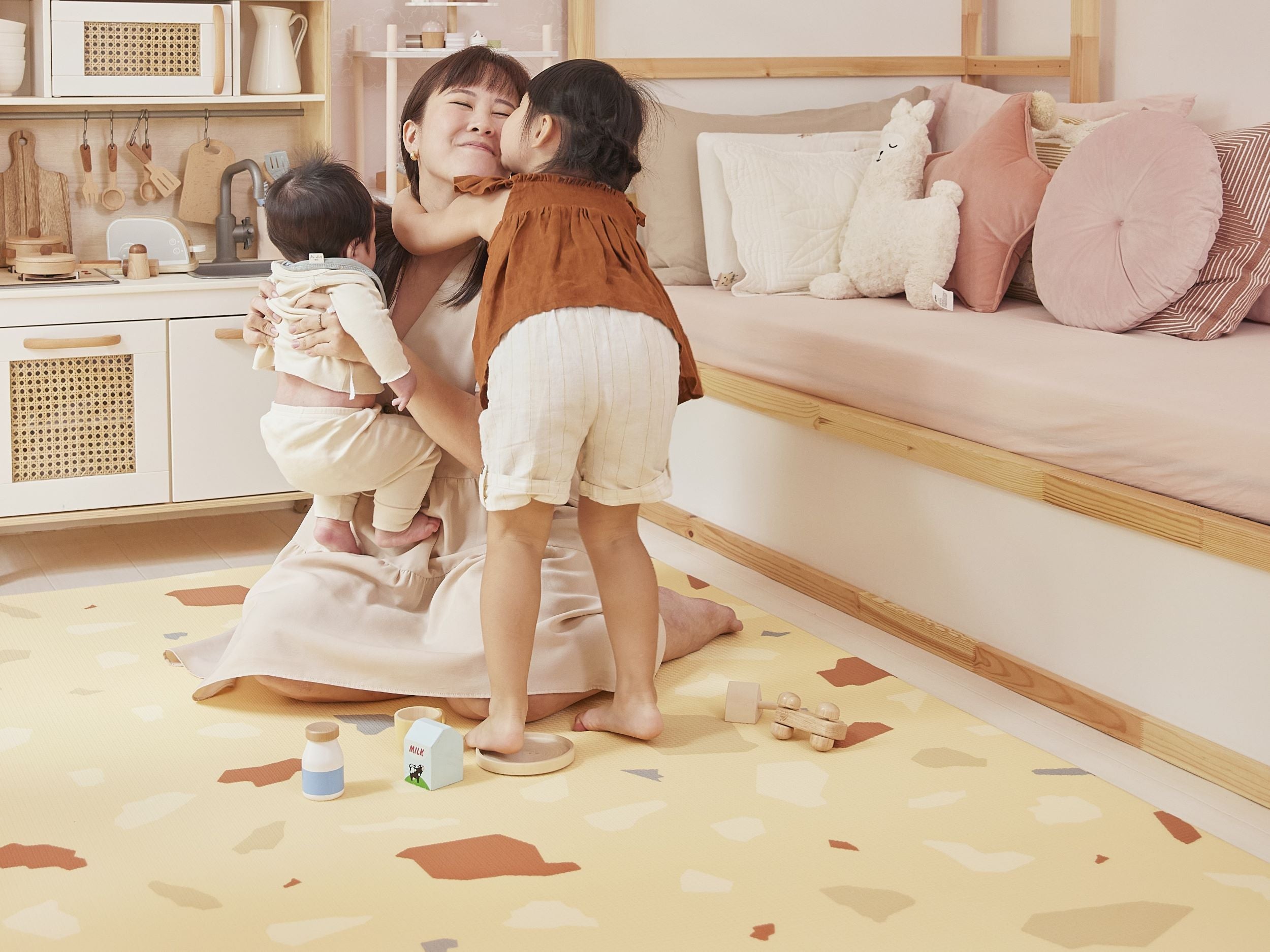 mom with kids on lollibly terrazzo play mat