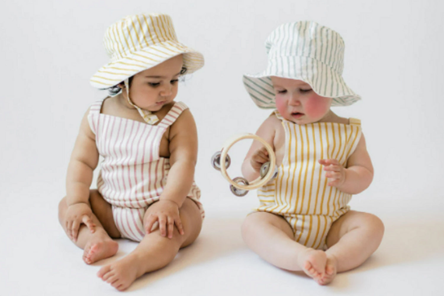 babies playing with tambourine and wearing pehr stripes away apparel