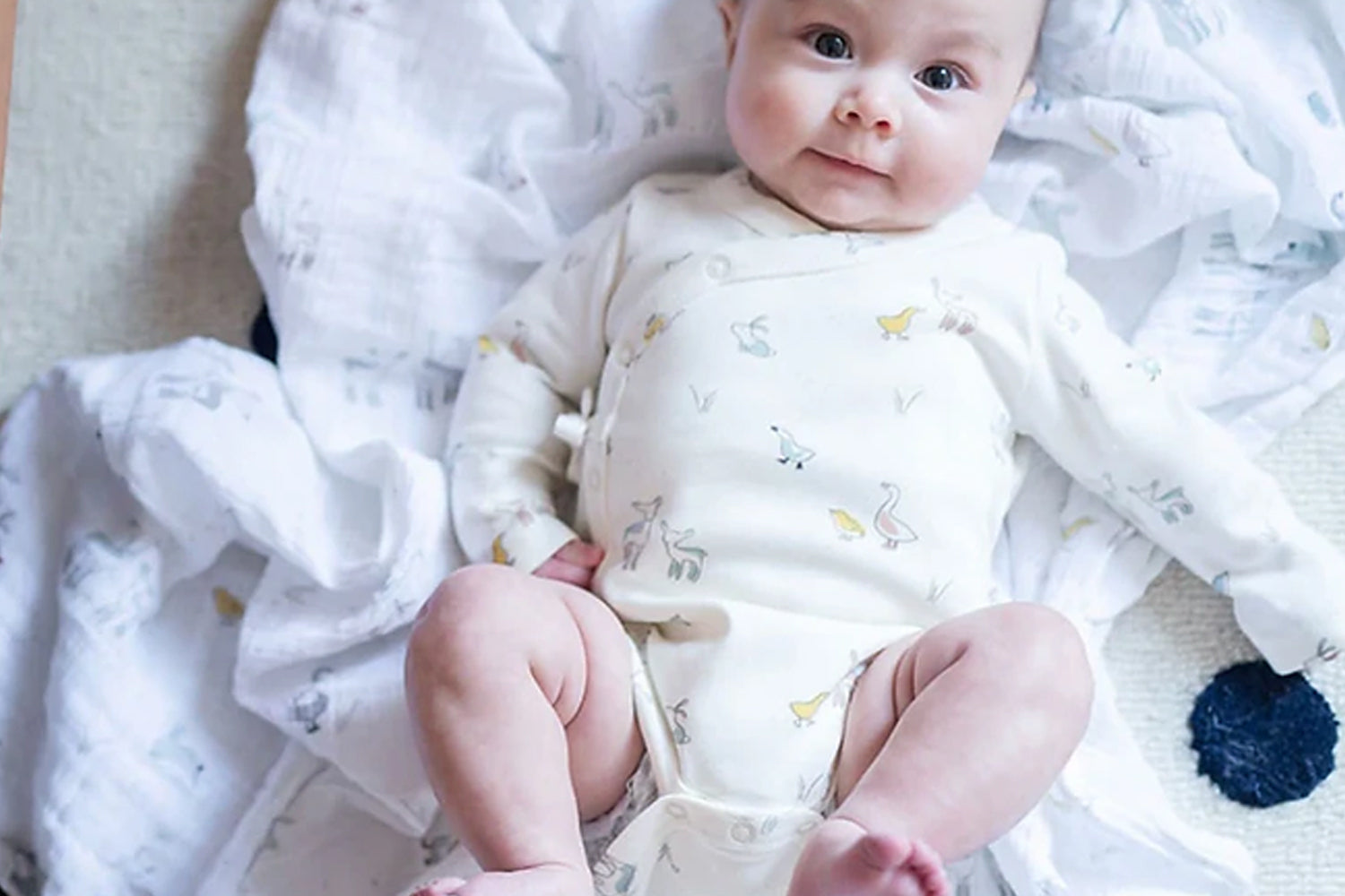 cute baby lying on swaddle