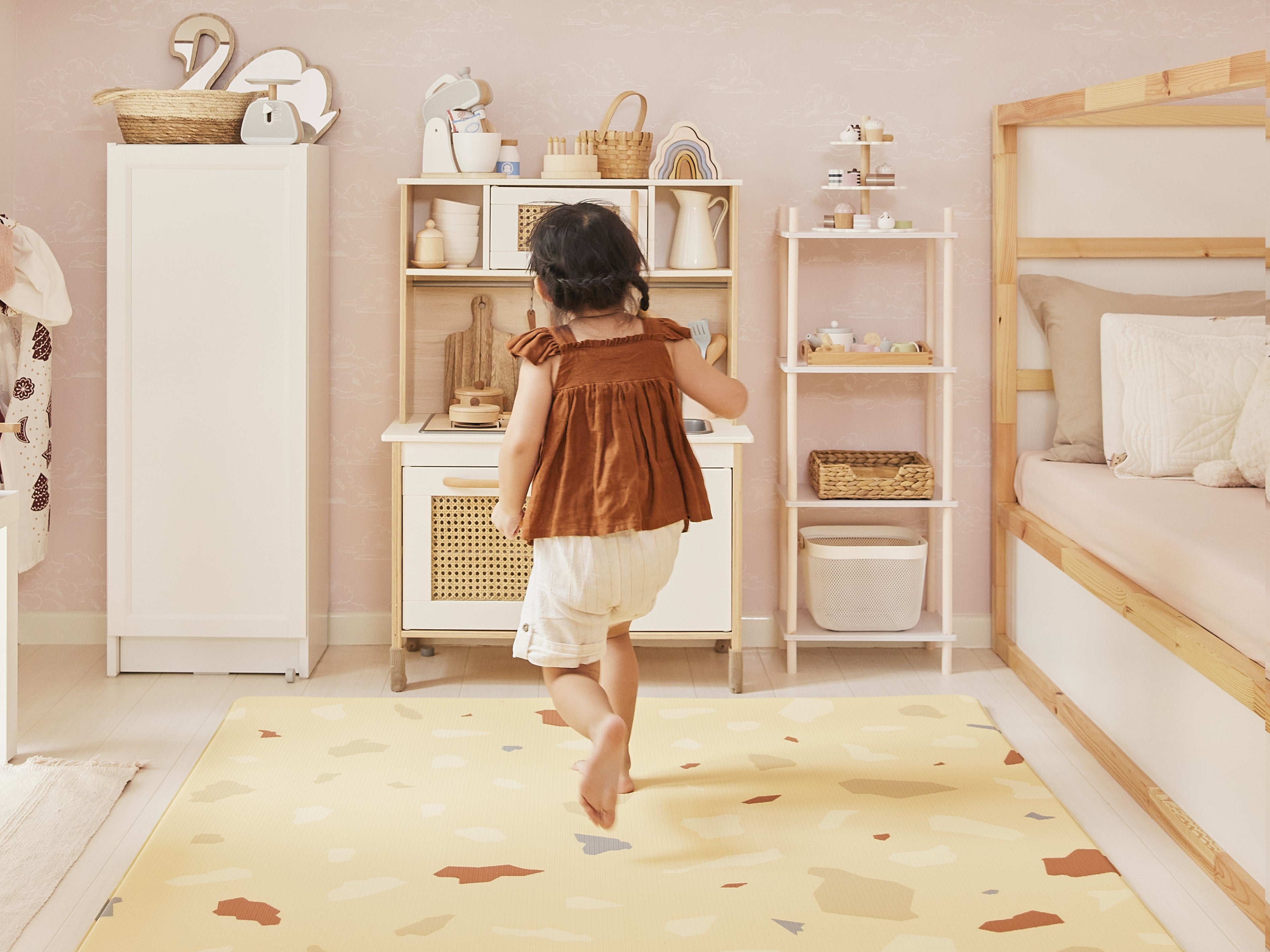 girl running on lollibly terrazzo play mat