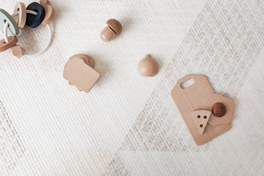 wooden toy blocks on lollibly sand dune playmat